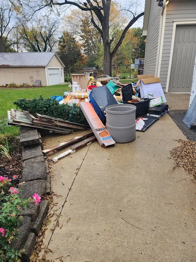Dumpster being loaded with debris for Estate Cleanout Dumpster Rental in Woodland